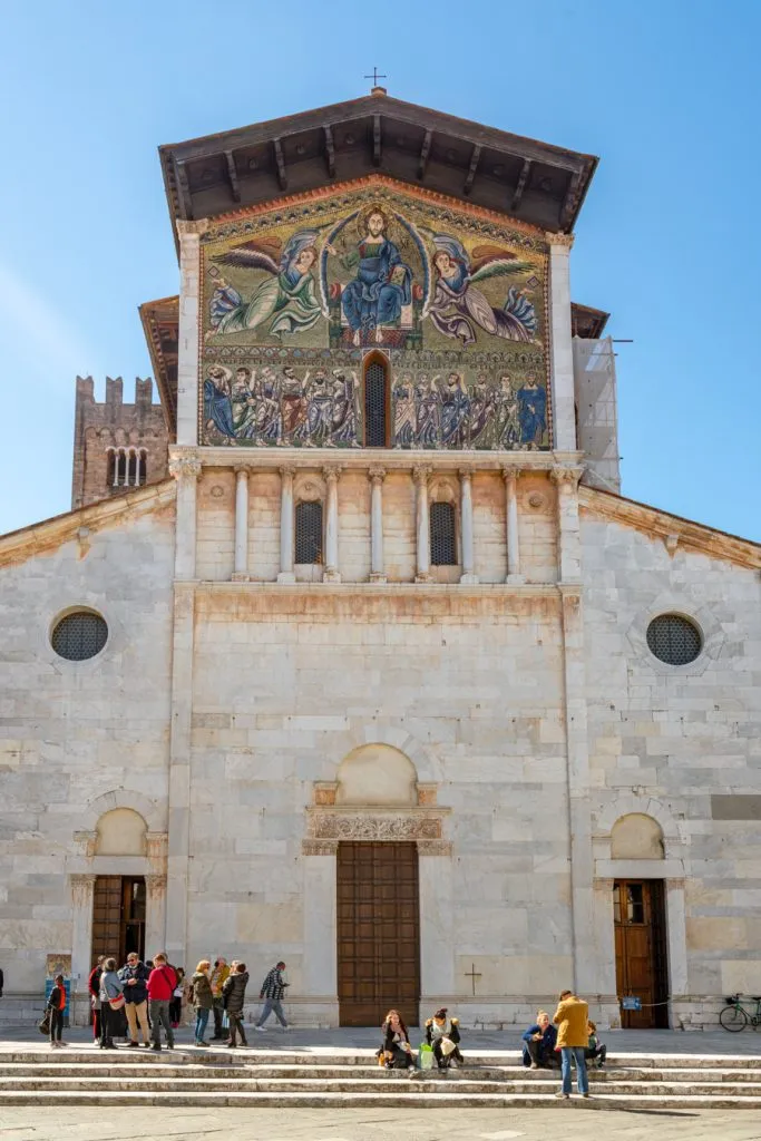 front facade of the basilica of san freidano with gold mosaic, one of the best things to do lucca italy