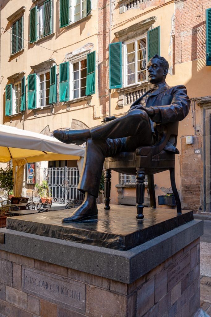 statue of puccini in front of the composers former home in lucca italy