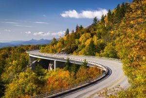linn cove viaduct on blue ridge parkway with early fall foliage, one of the best southern usa road trip itineraries
