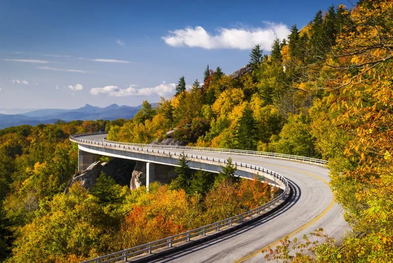 linn cove viaduct on blue ridge parkway with early fall foliage, one of the best southern usa road trip itineraries