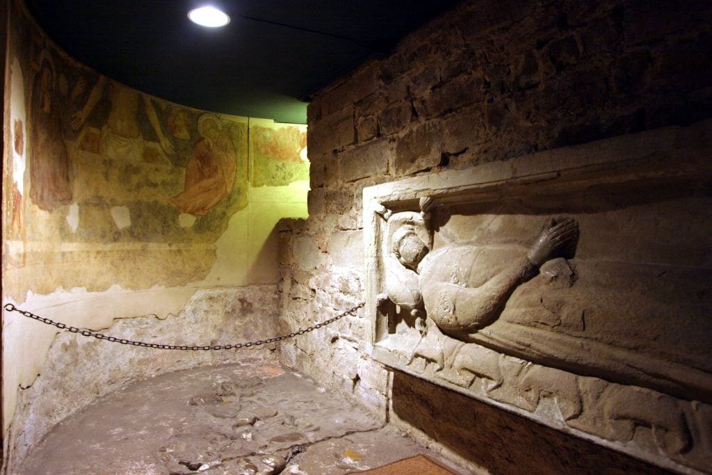 historic fresco and statue in crypt florence