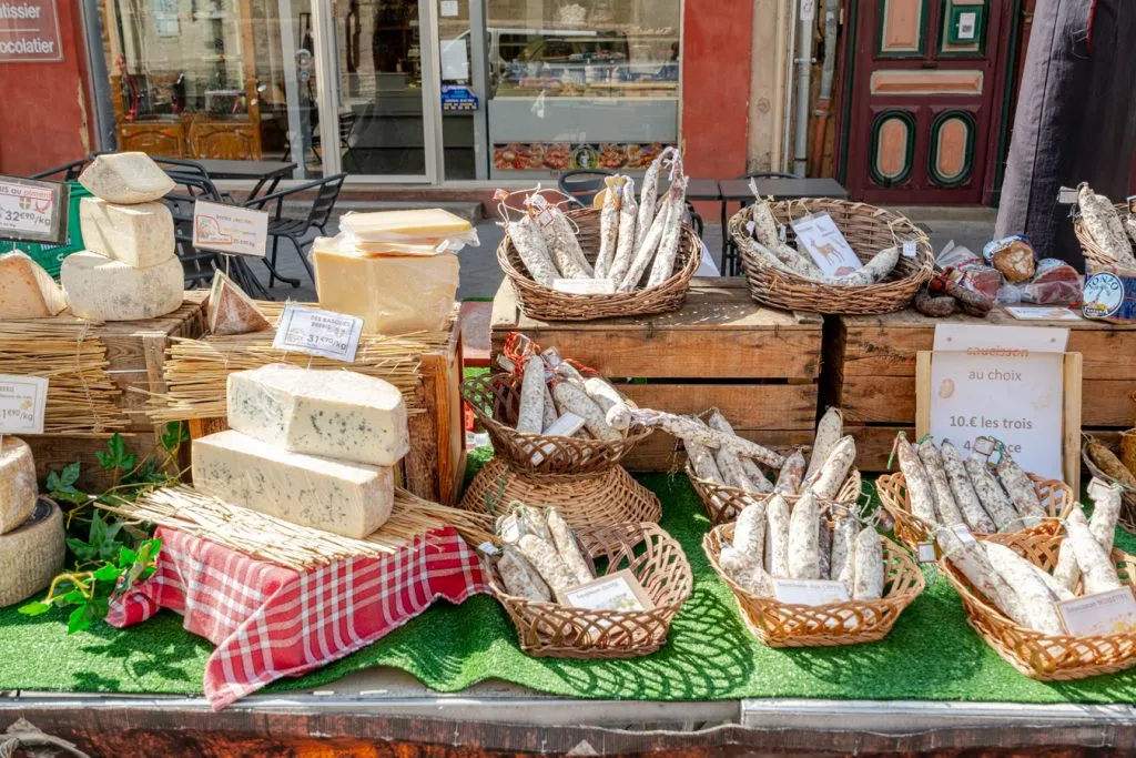 selection of cheese and sausage for sale at provencal market