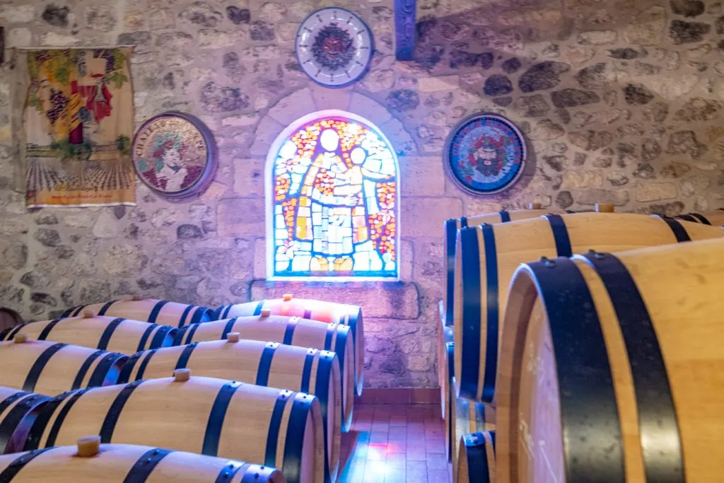 wine barrels in the stone basement of a saint emilion chateau