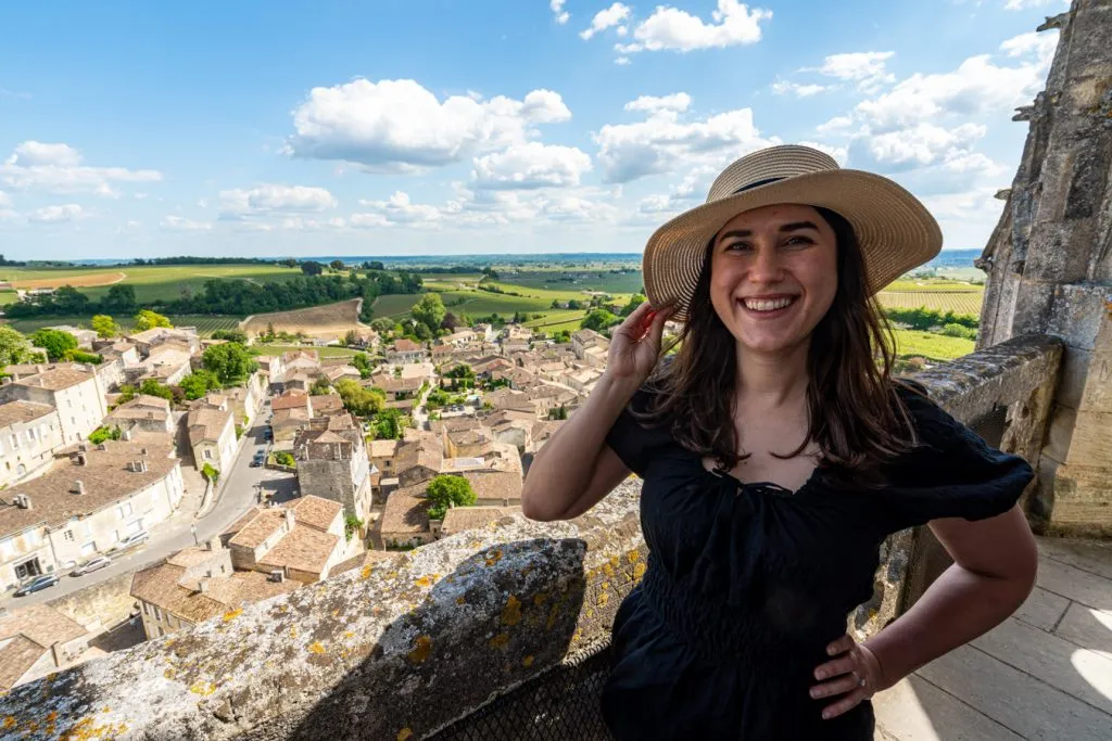 kate storm in a black dress at the top of the bell tower, one of the top activities saint emilion france