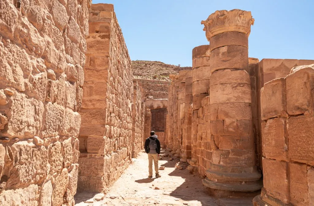 jeremy storm walking amongst stone columns in petra jordan