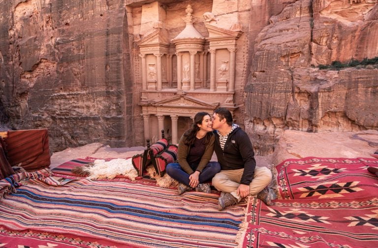 kate storm and jeremy storm in front of the petra treasury on a road trip jordan itinerary