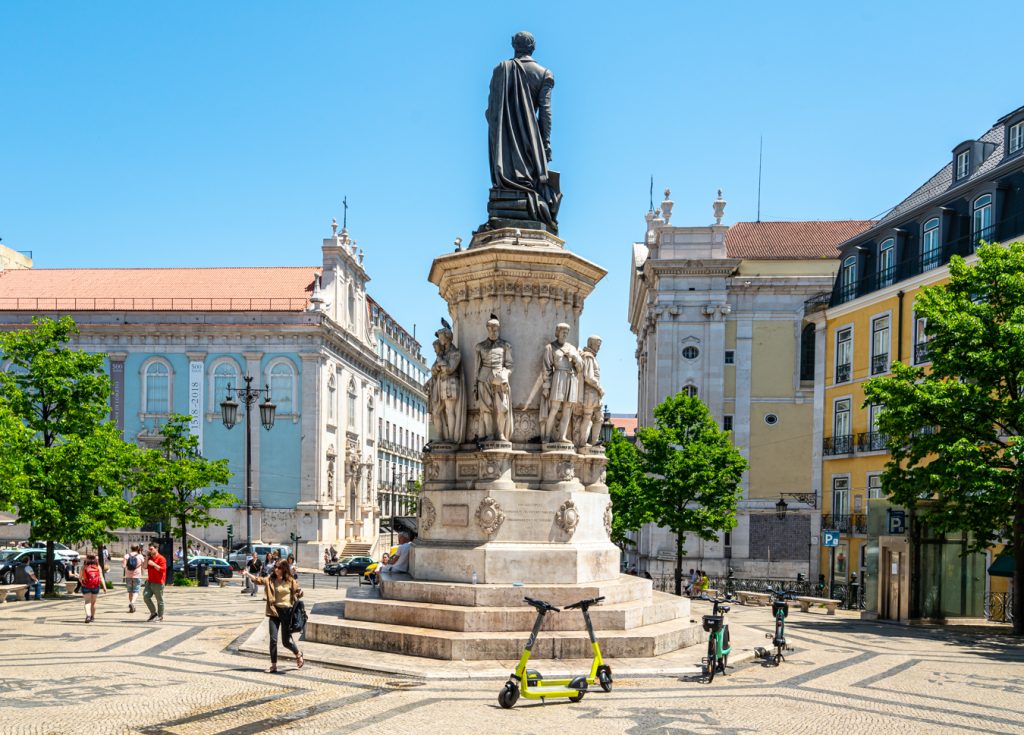 statue in the center of a square in chiado lisbon