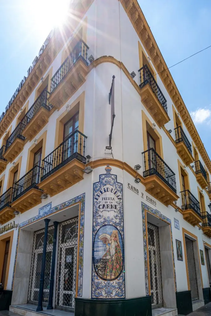colorful white and yellow building barrio santa cruz seen during a day in seville spain