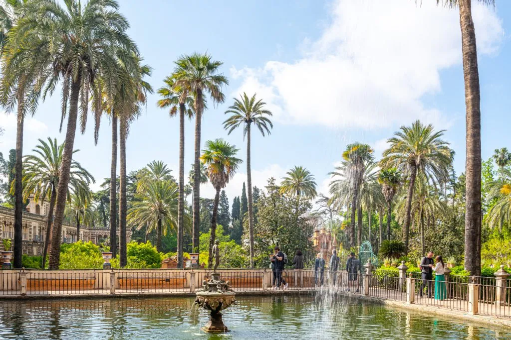 alcazar gardens seville spain with a fountain in the foreground