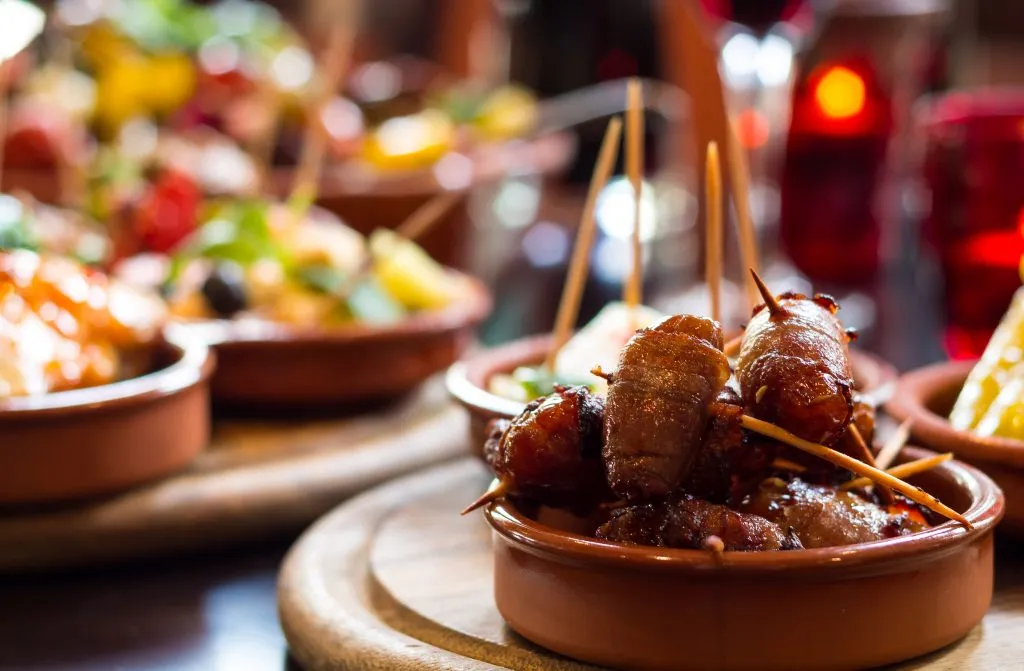round plates of spanish tapas with toothpicks in them