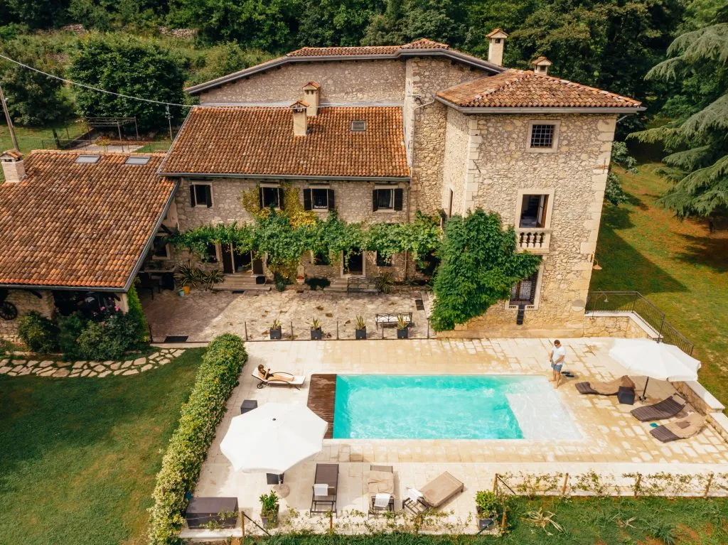 aerial view of couple renting a tuscan villa with a pool