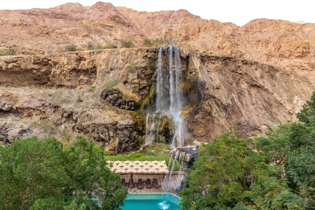 ma'in hot springs resort with waterfall in center