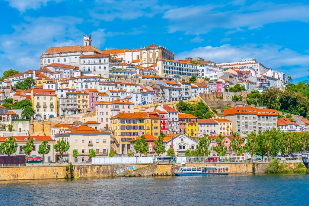 cityscape of coimbra portugal as seen from the river, a fun stop on a lisbon to porto drive