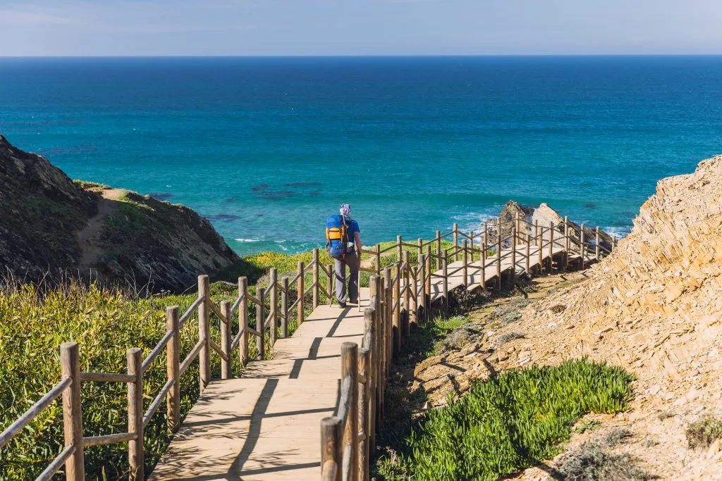 man hiking along fishermans trail portugal