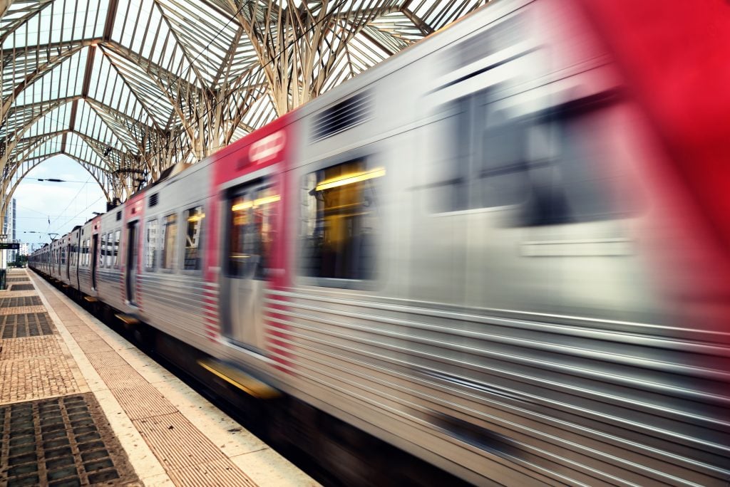 long exposure of a train leaving a lisbon train station, traveling lisbon to porto train tickets