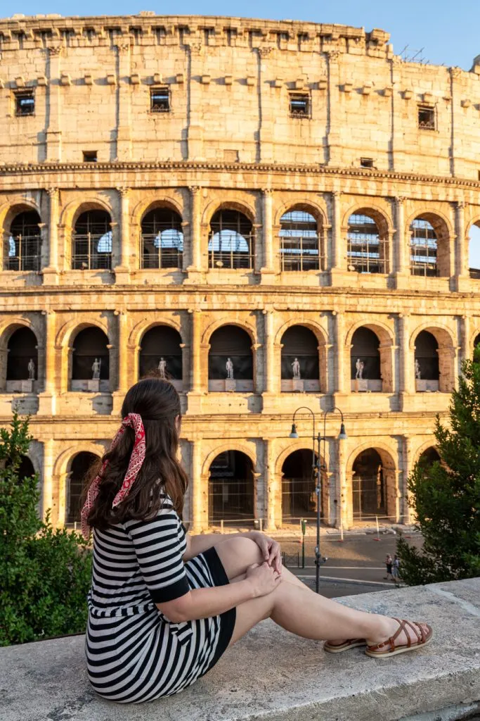 kate storm in a striped dress in front of colosseum rome italy