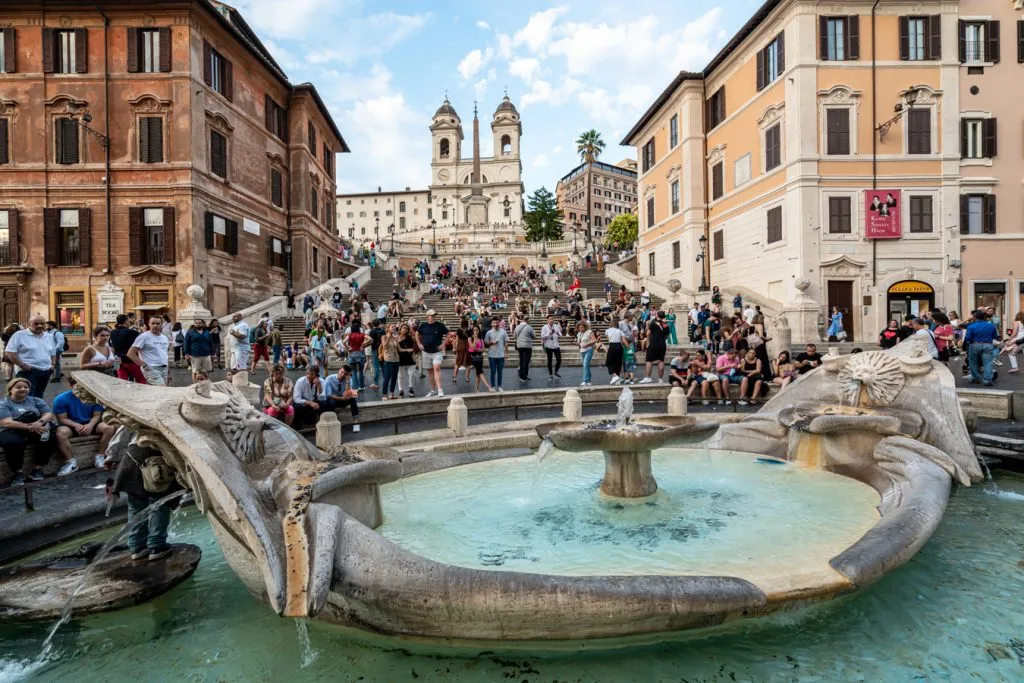 busy spanish steps with fountain in foreground as seen when traveling rome italy