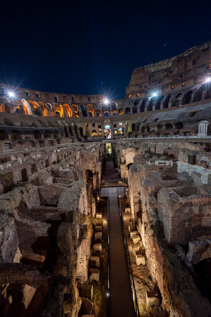 rome colosseum at night as seen from the inside
