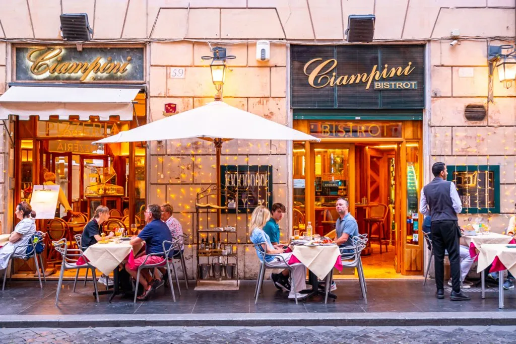 tourists sitting down for a meal at a restaurant in rome italy