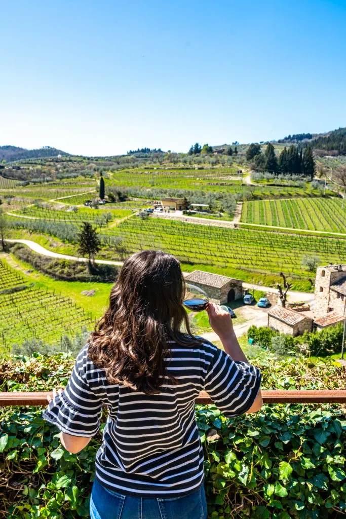 kate storm drinking wine overlooking vineyards in tuscany