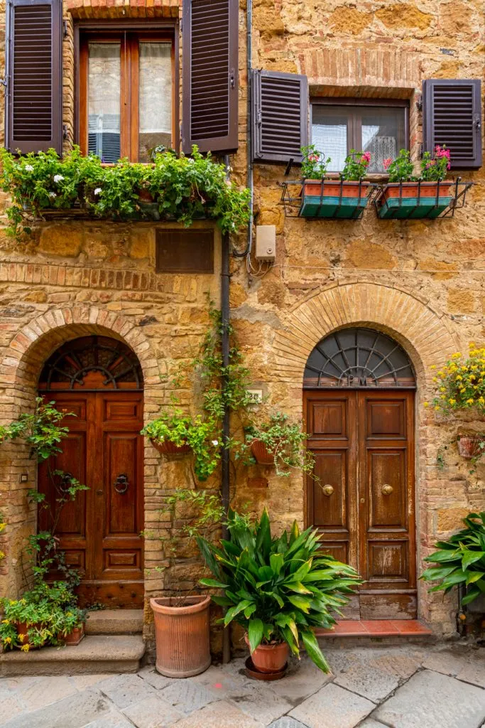 front facades of houses with greenery, one of the best places to visit in pienza italy