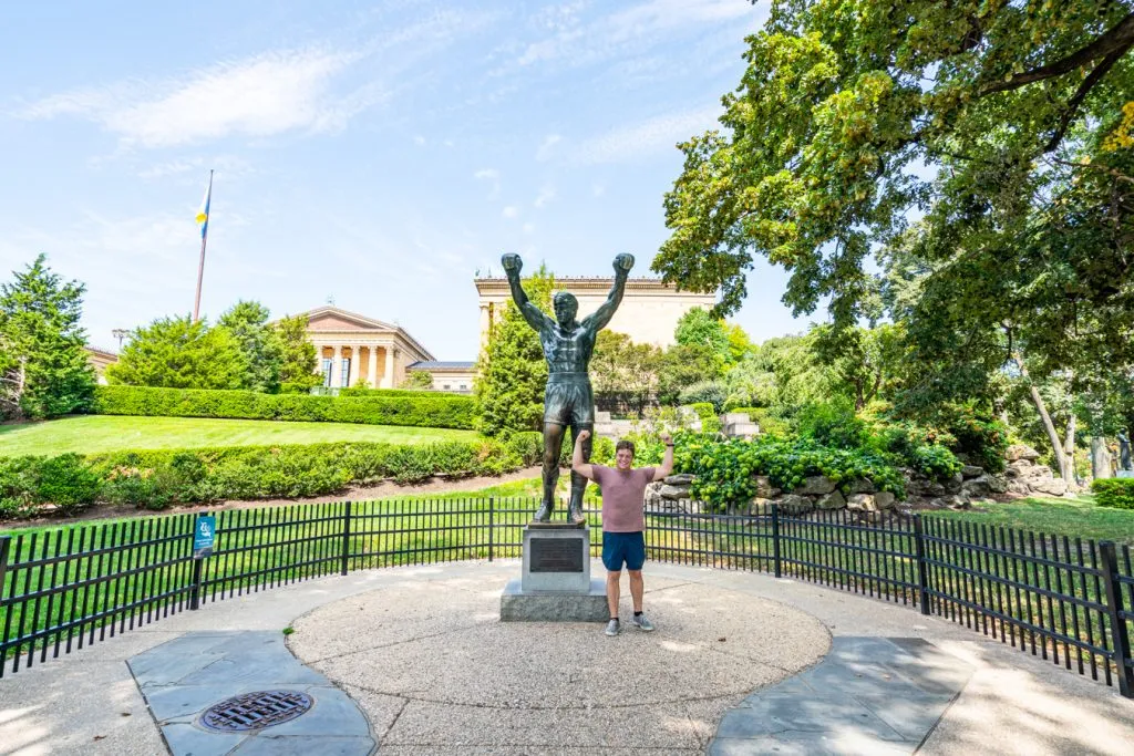 jeremy storm posing with rocky statue during a 3 day philadelphia itinerary