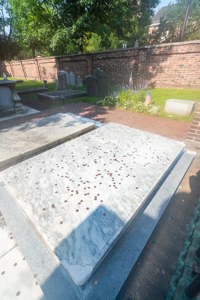 benjamin franklin grave with pennies on top of it at christ church burial ground