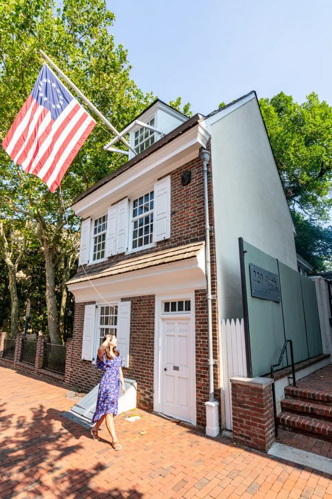 kate storm in front of betsy ross house during a long weekend in philly itinerary