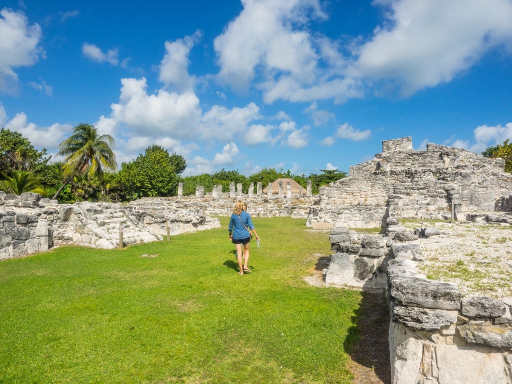 tourist walking through mayan ruins mexico cancun, el rey