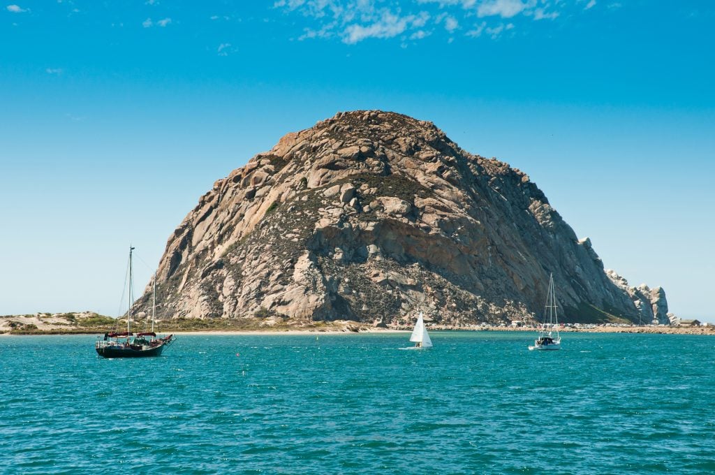 famous morro rock in morro bay ca with boats in the foreground