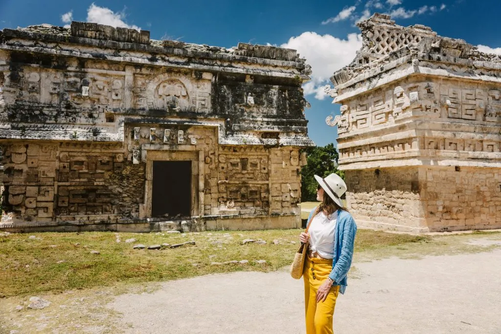 young woman walking in front of historic buildings chichen itza mexico archaeological sites