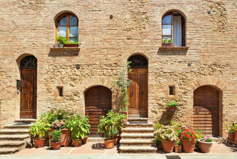 front doors of houses with greenery as seen when visiting pienza italy tuscany