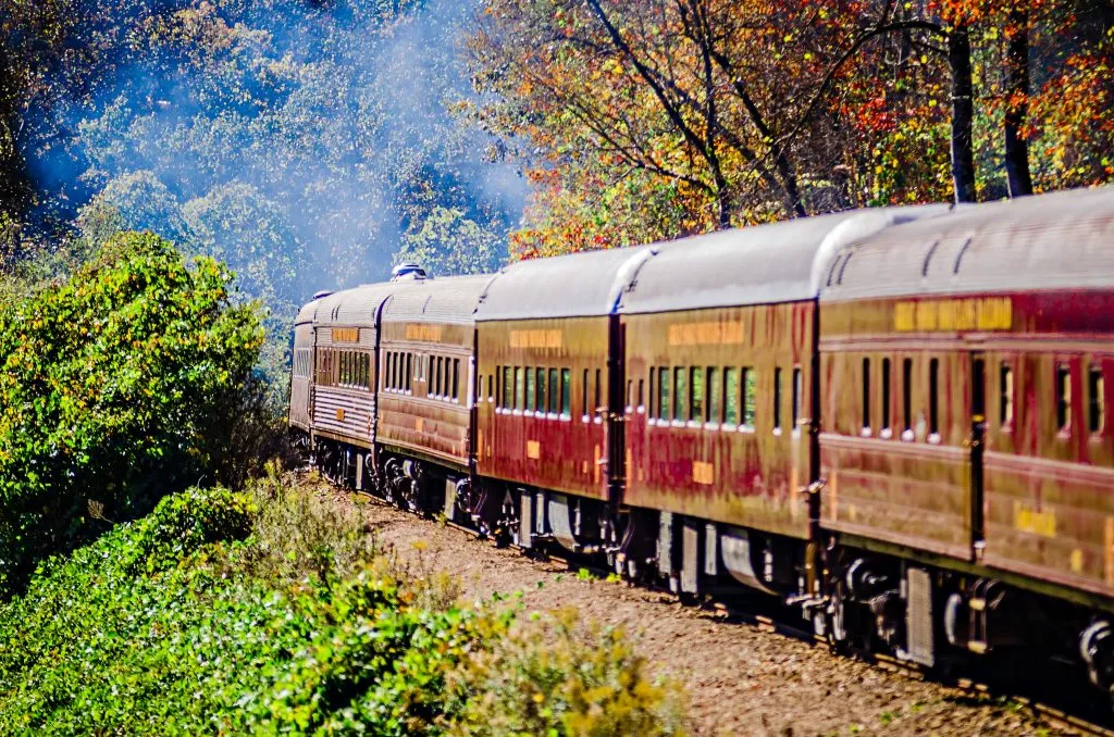 great smoky mountains railroad passenger cars as seen during the fall, one of the best places to visit in western nc