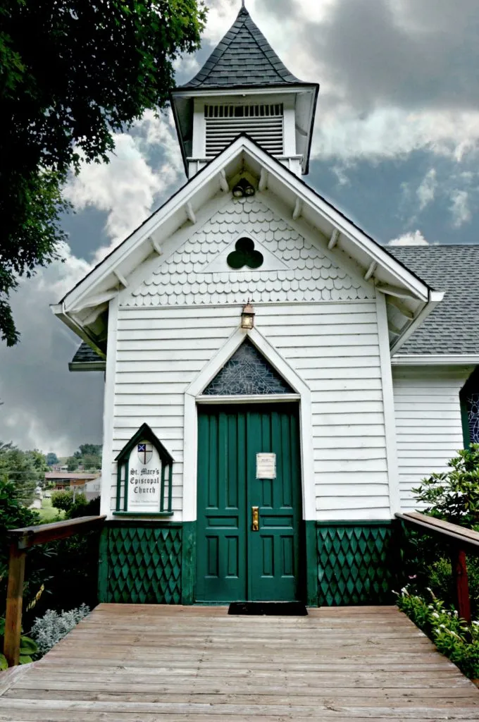 front white and green facade of church of the frescoes in west jefferson nc