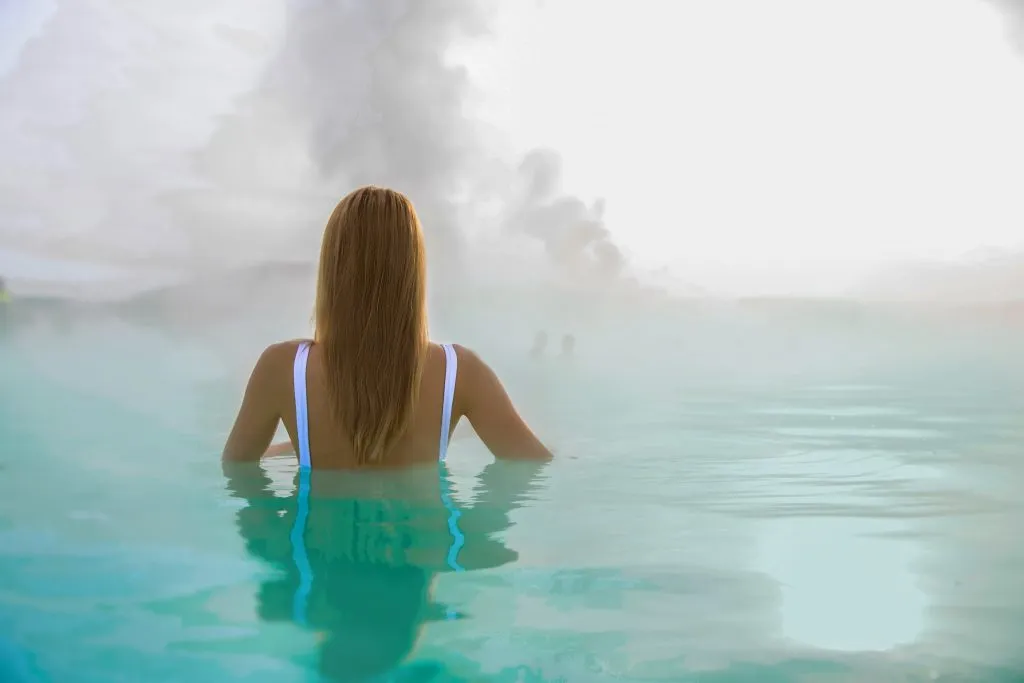 woman soaking in a geothermal spa iceland