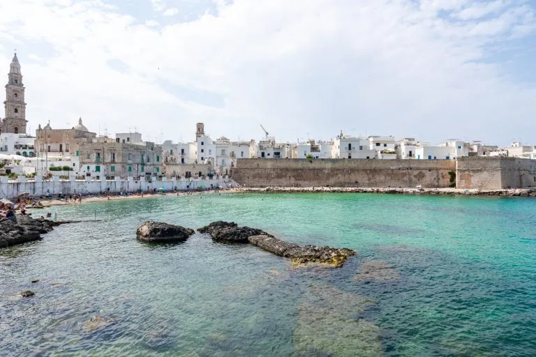 monopoli italy as seen from across the water, one of the best places to visit during summer in italy puglia