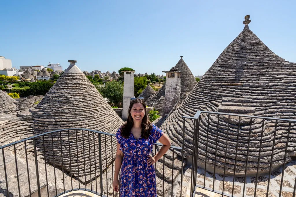 kate storm standing in front of trulli in alberobello italy