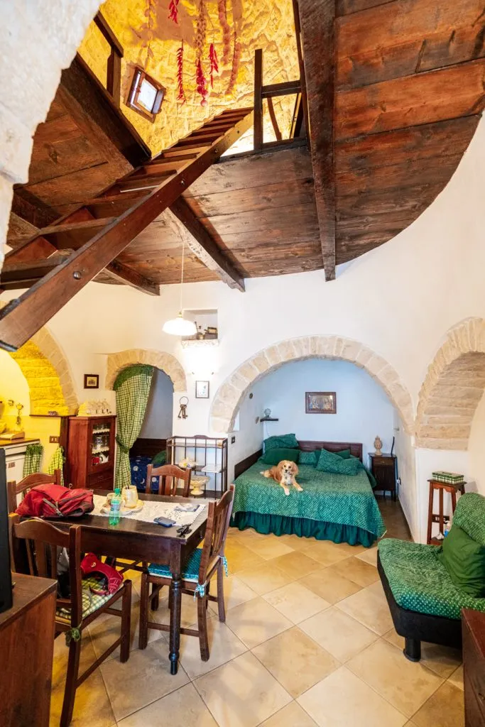 interior of a trullo in alberobello italy with ranger storm lying on the bed