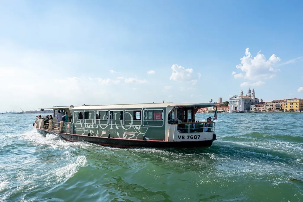 view of a vaporetto driving across the venetian lagoon visiting islands of venice italy