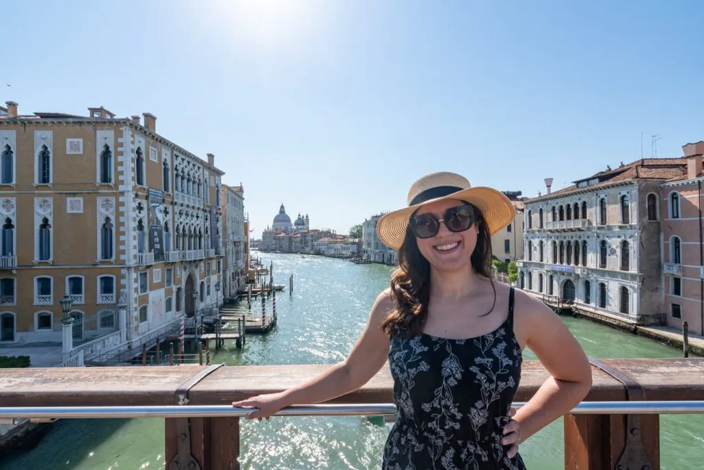 kate storm standing on the ponte dell'accademia in venice in a black dress
