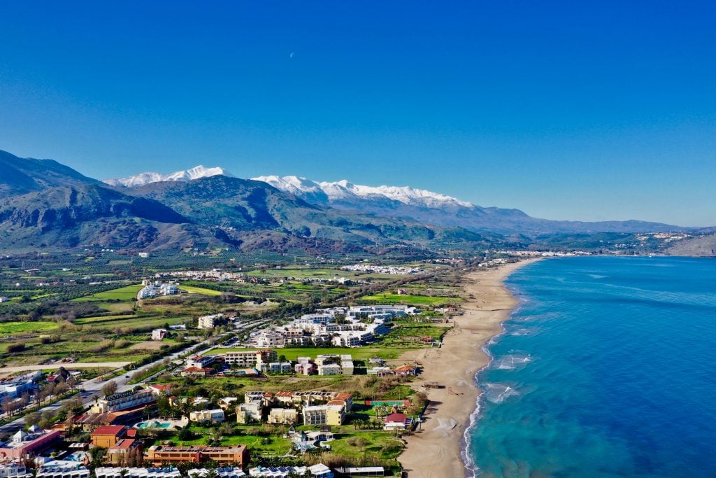 view of crete greece in winter from above with beach in foreground and mountains in background