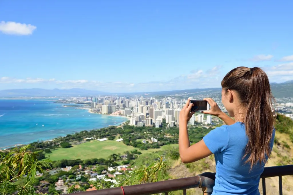 woman photographing the view from diamond head, one of the best attractions in oahu hawaii