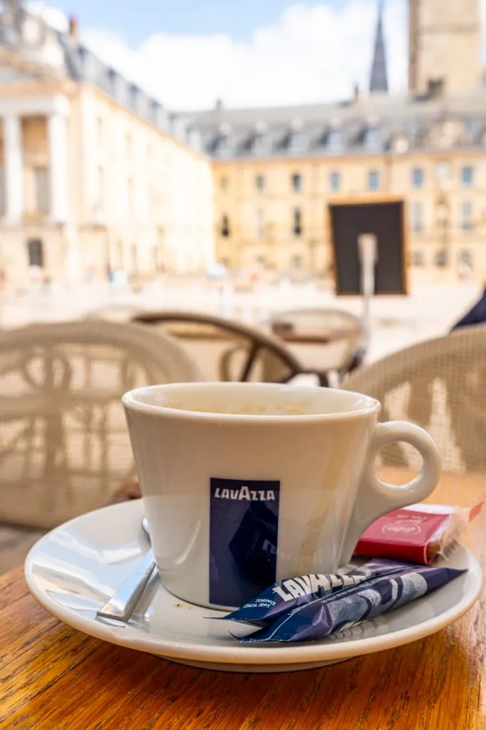 coffee at a cafe outdoors in dijon france with liberation square in the background