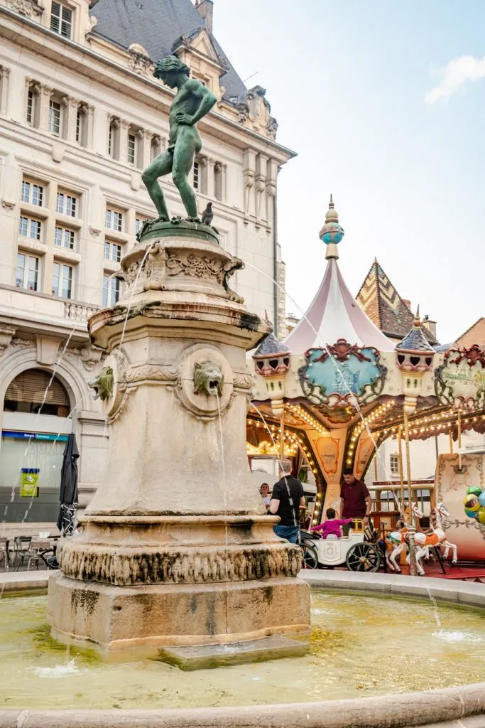 francois rude square, one of the best places to visit in dijon france with fountain in foreground