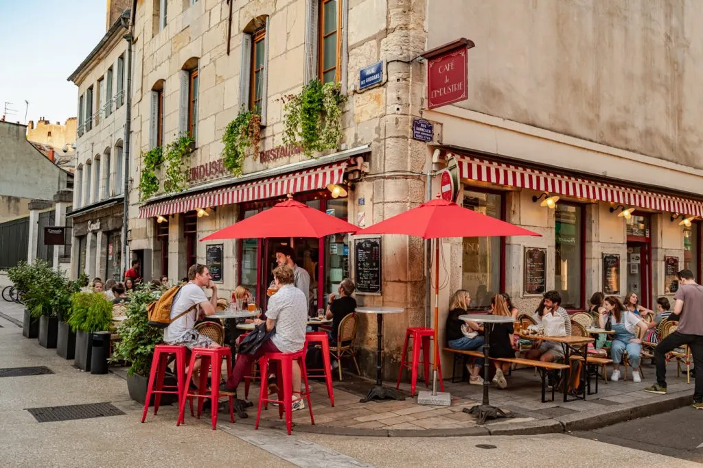 people eating dinner on a terrace at a restaurant dijon france
