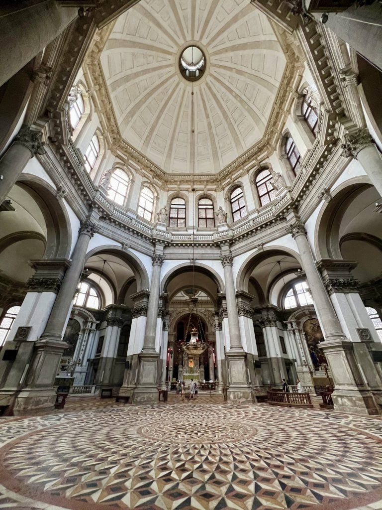 interior of basilica di santa maria della salute in dorsoduro, with marble floor prominent