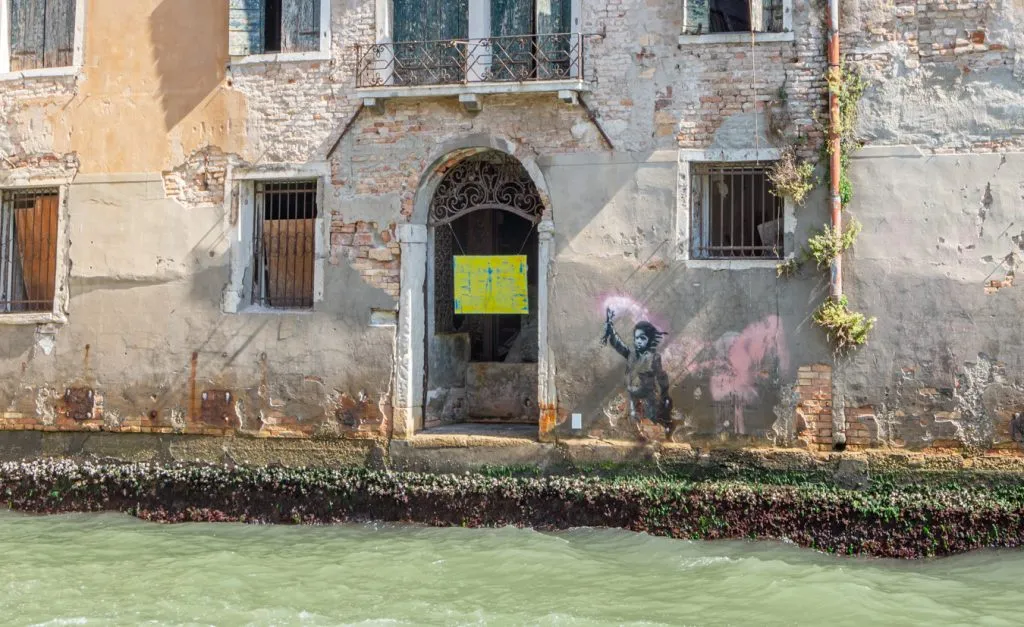 banksy migrant child mural as seen along a canal in dorsoduro venice italy
