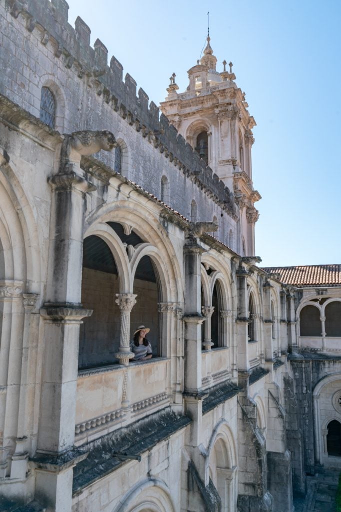 kate storm standing in a window of alcobaca monastery on a day trip from lisbon portugal