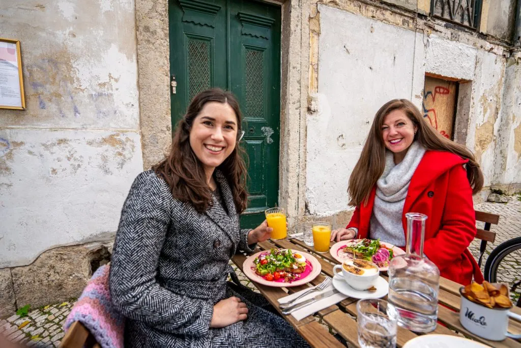 kate storm and brittany kulick enjoying brunch outdoors during winter in lisbon portugal