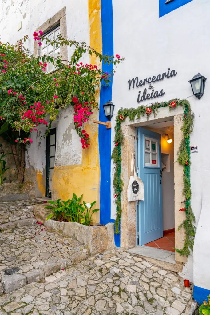 colorful street and shop entrance in obidos portugal